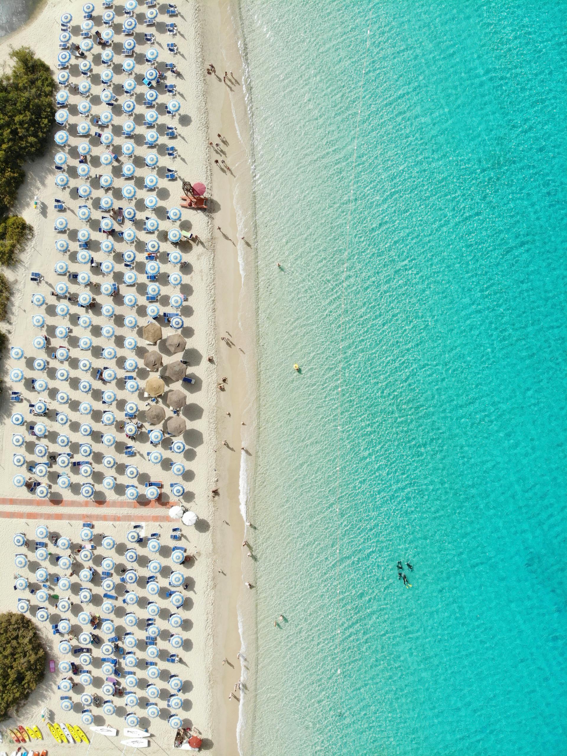 Stunning aerial photo of the beach in Geremeas, Sardinia with clear turquoise waters.