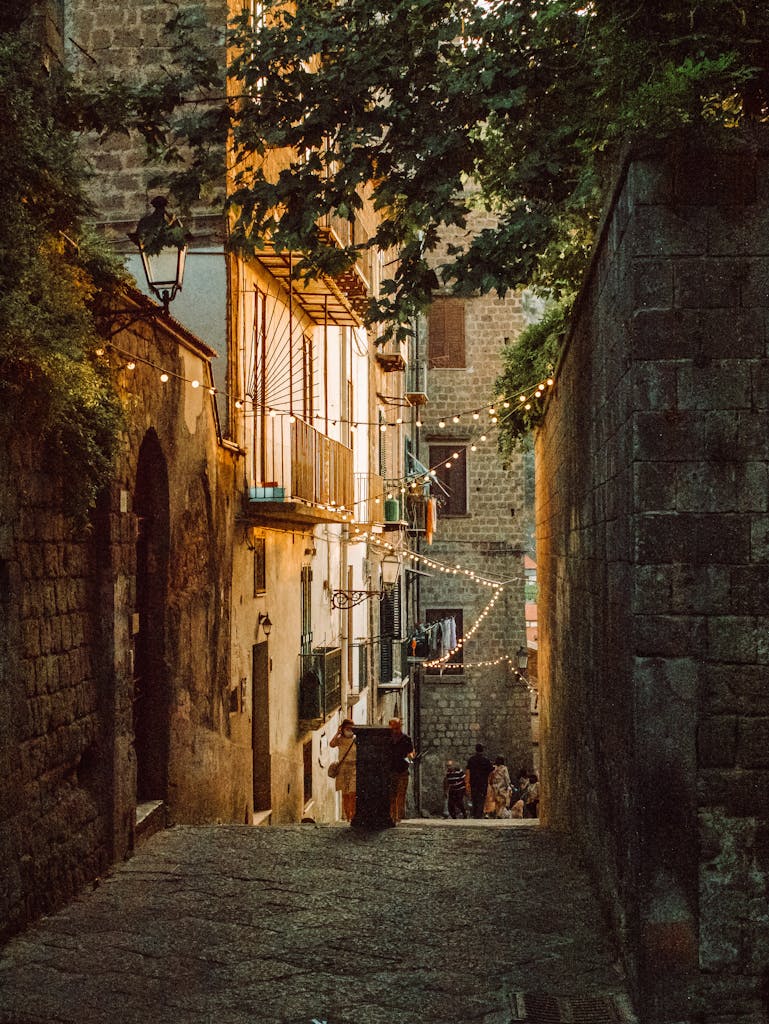 A picturesque alley in Sorrento, Italy, illuminated by warm lights at dusk, capturing the essence of Italian architecture and ambiance.