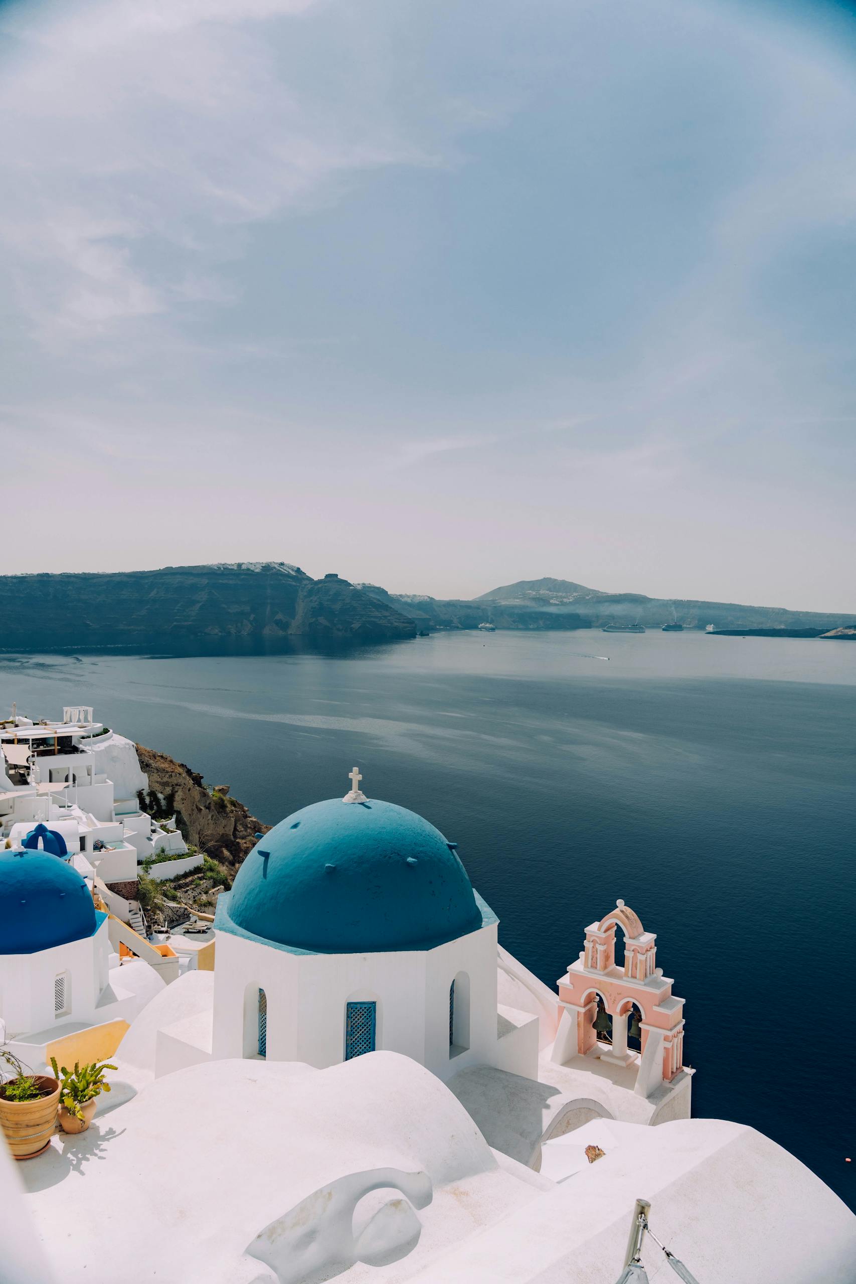 Greece's Santorini with blue domes and sea, perfect summer getaway.