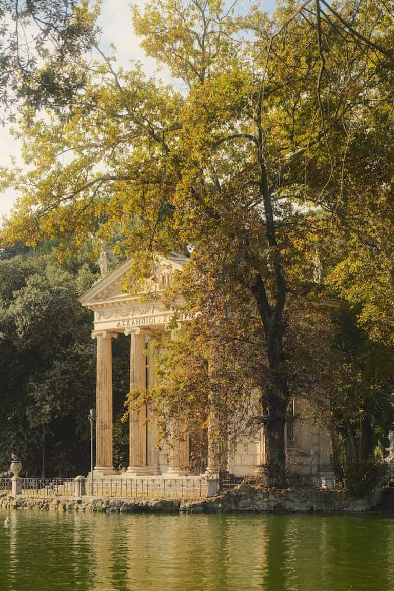 Serene view of Temple of Aesculapius surrounded by autumn foliage in Rome. A perfect place to add to a 1 day Rome itinerary