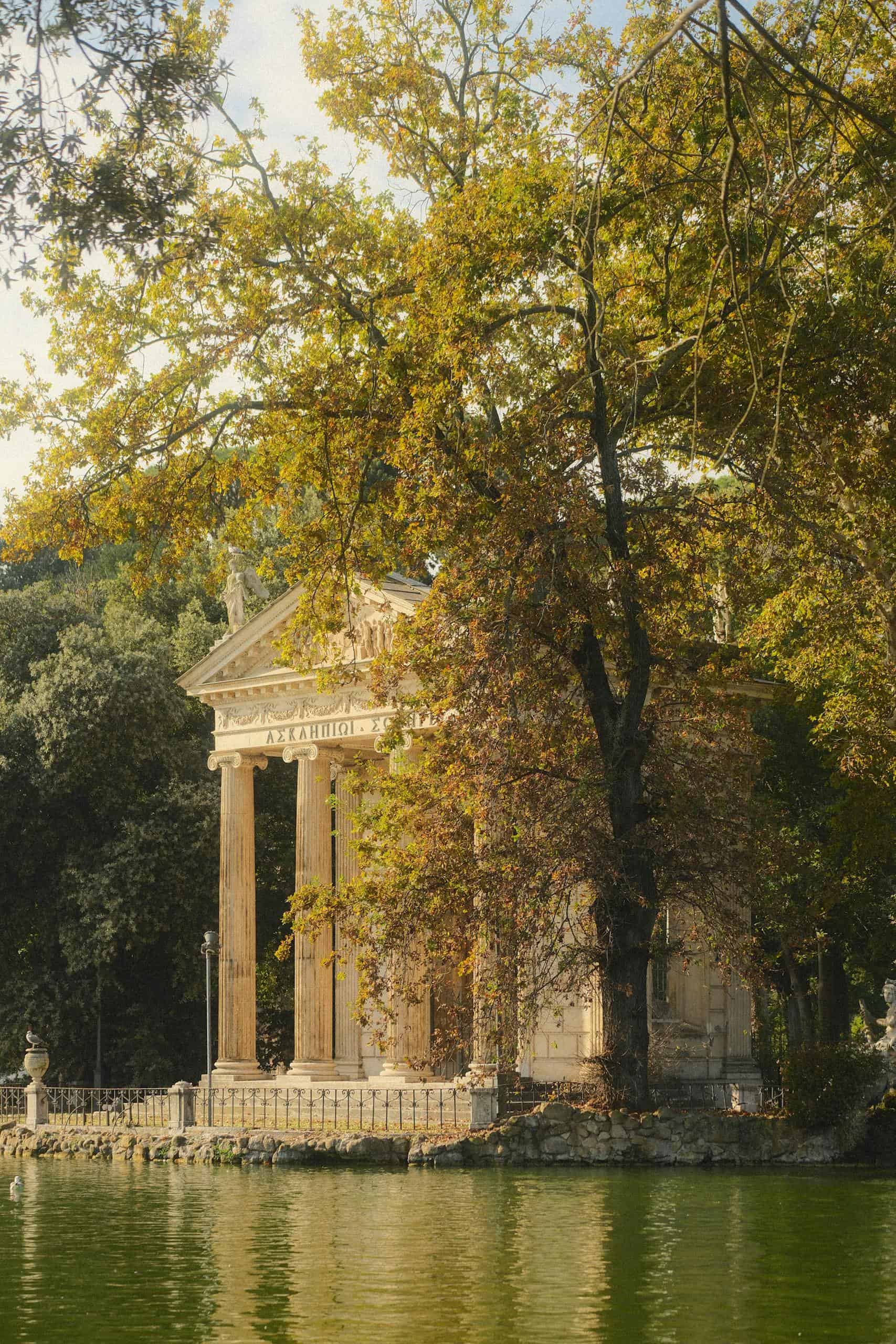 Serene view of Temple of Aesculapius surrounded by autumn foliage in Rome. A perfect place to add to a 1 day Rome itinerary