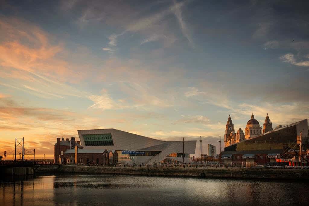 Beautiful view of Liverpool's iconic waterfront with buildings and the Museum of Liverpool at sunset.