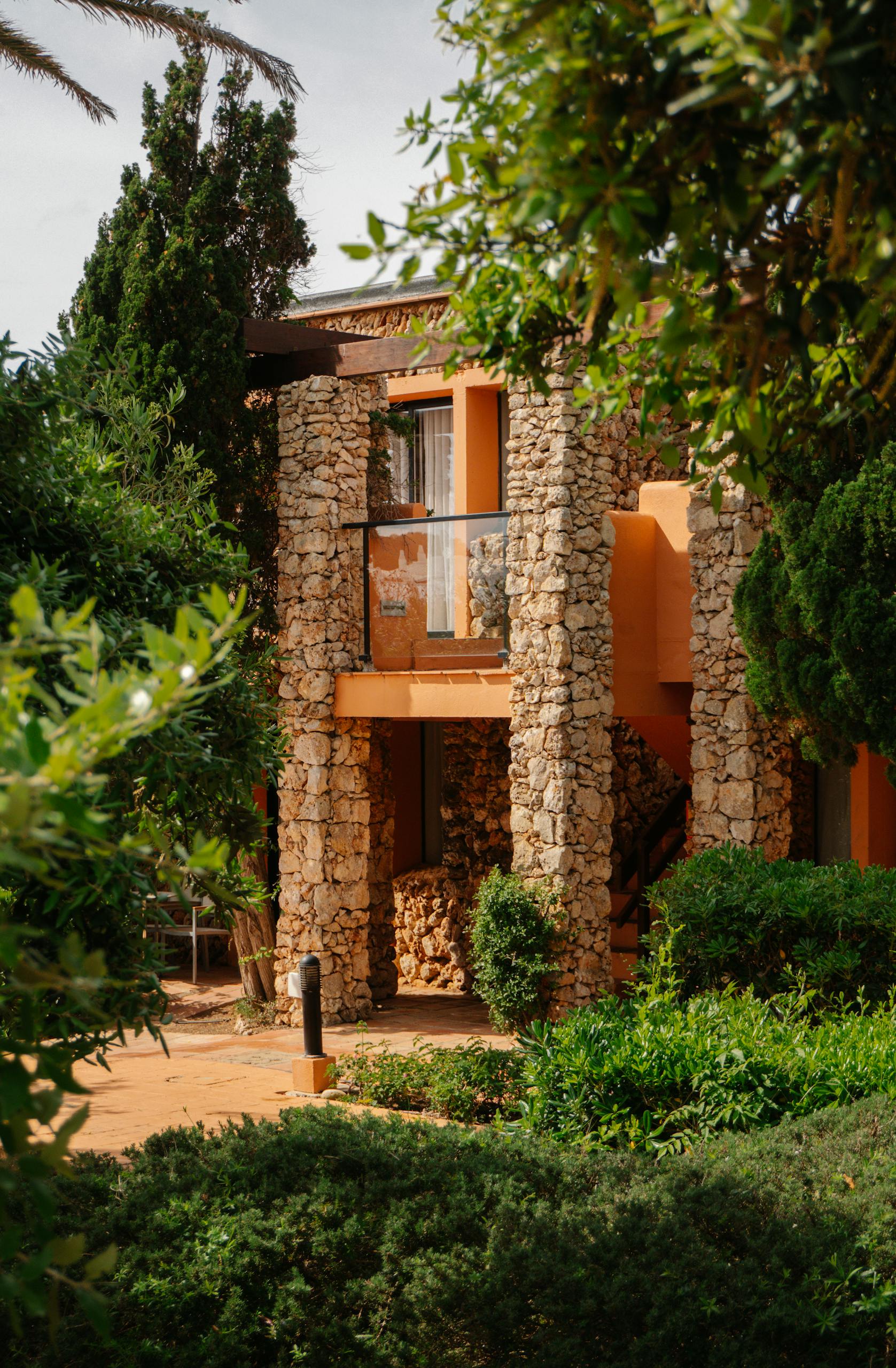 Rustic stone villa surrounded by lush greenery in Ciutadella de Menorca.