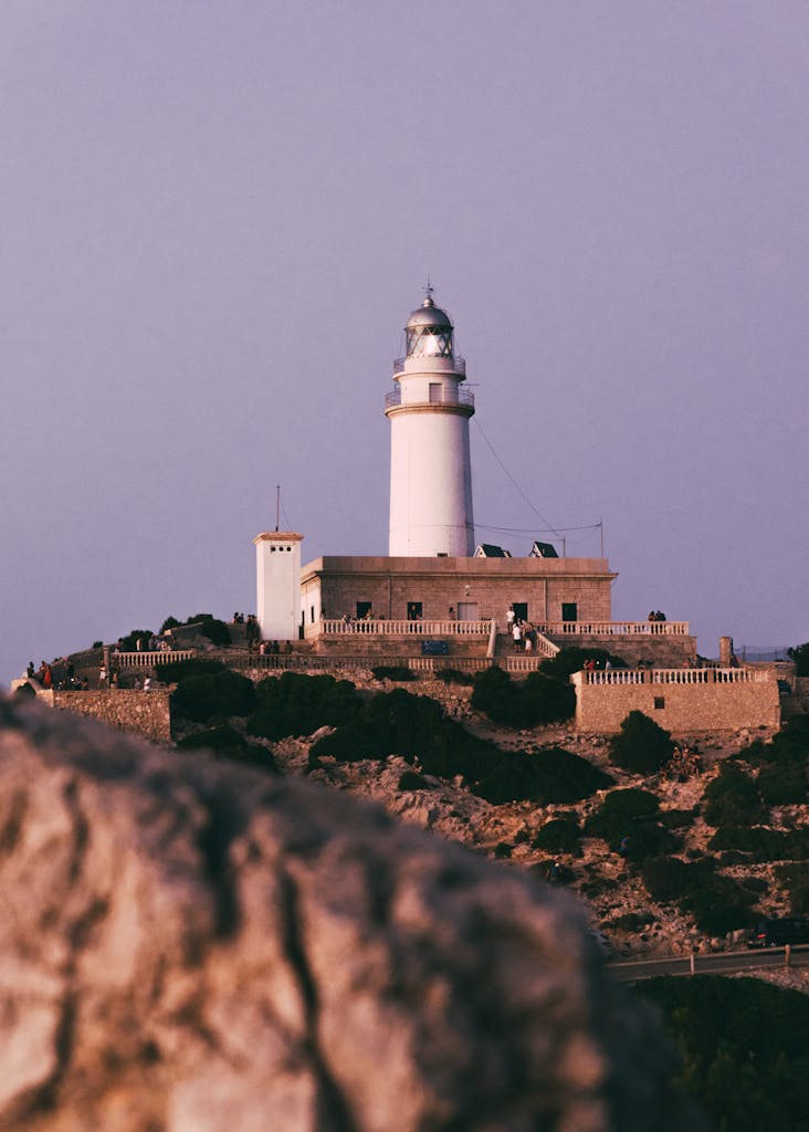 Serene sunset view of Cap de Formentor Lighthouse in Pollença, Majorca, Spain.