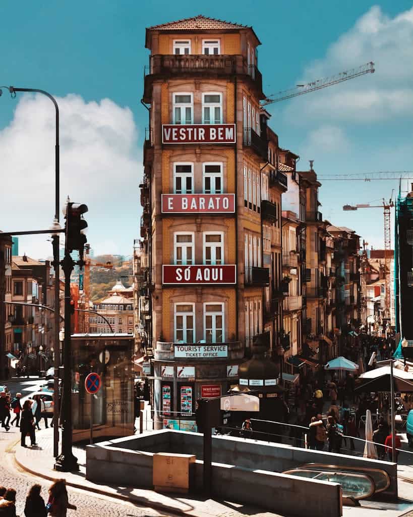 Vibrant street view of Porto with historical architecture and lively pedestrian activity.