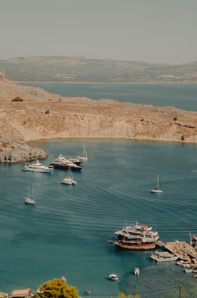 Aerial view of Lindos Bay showcasing yachts and stunning coastal scenery in Greece.