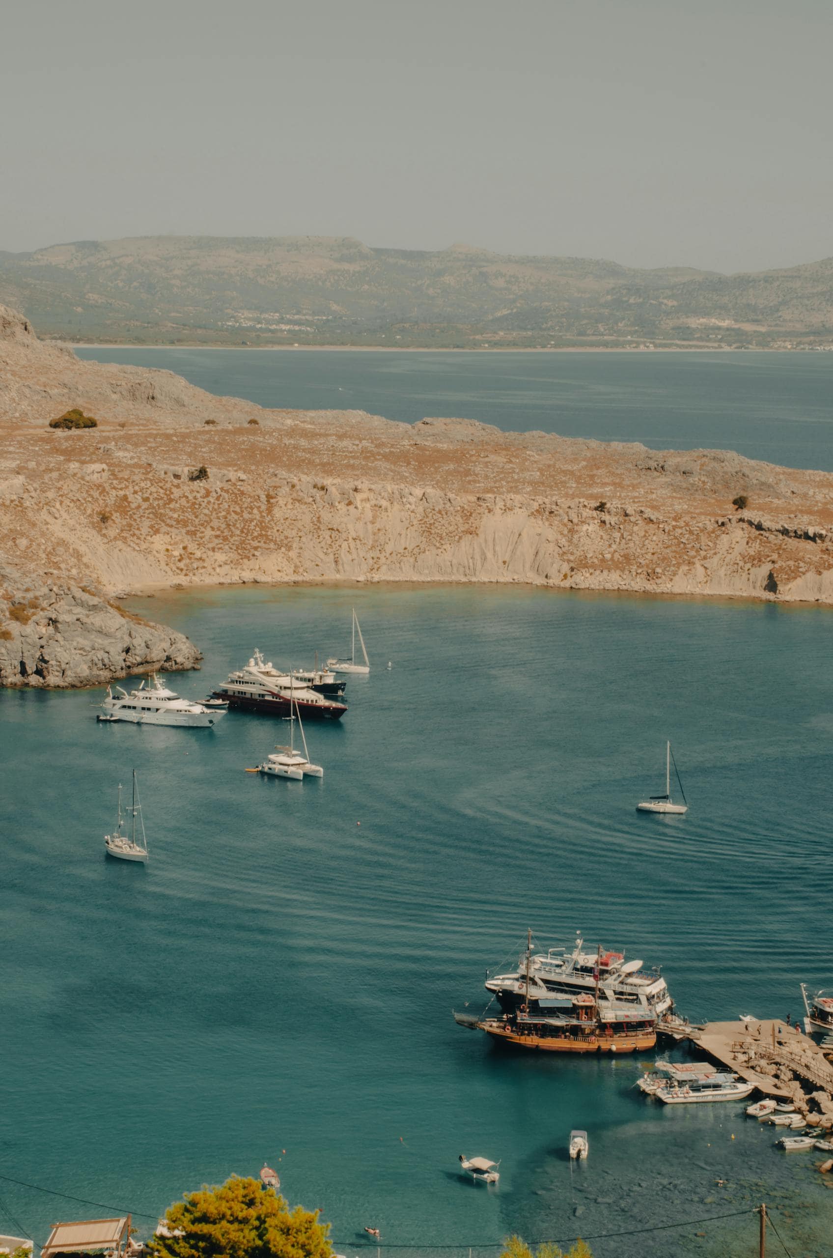 Aerial view of Lindos Bay showcasing yachts and stunning coastal scenery in Greece.