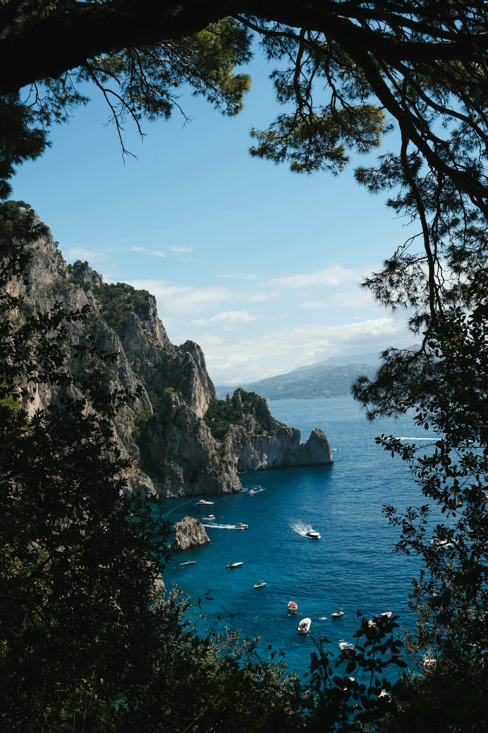 Discover the breathtaking cliffs and azure waters of Capri's enchanting coast, a perfect summer escape.
