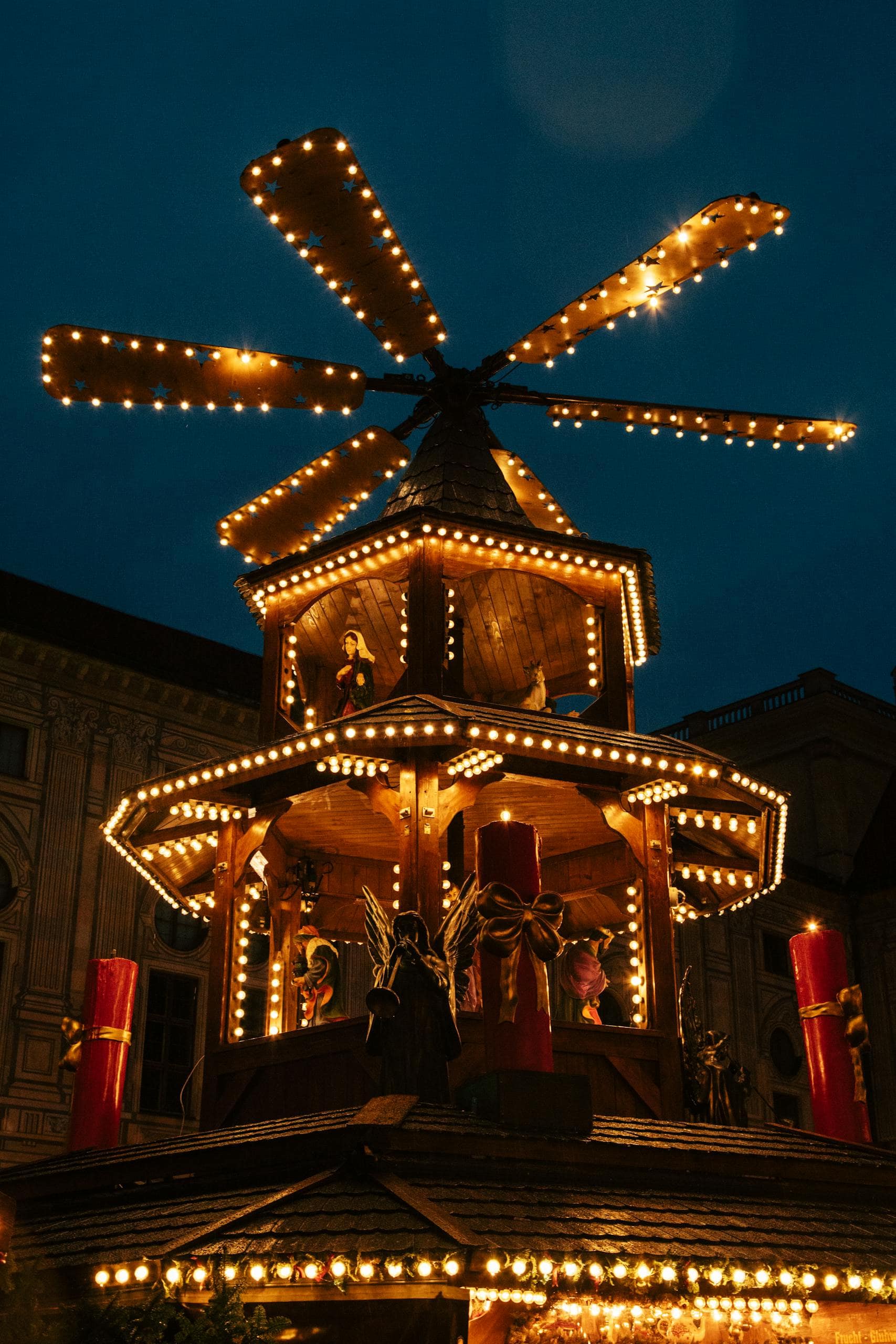 Festive wooden Christmas market spinner with lights in Munich, Germany.