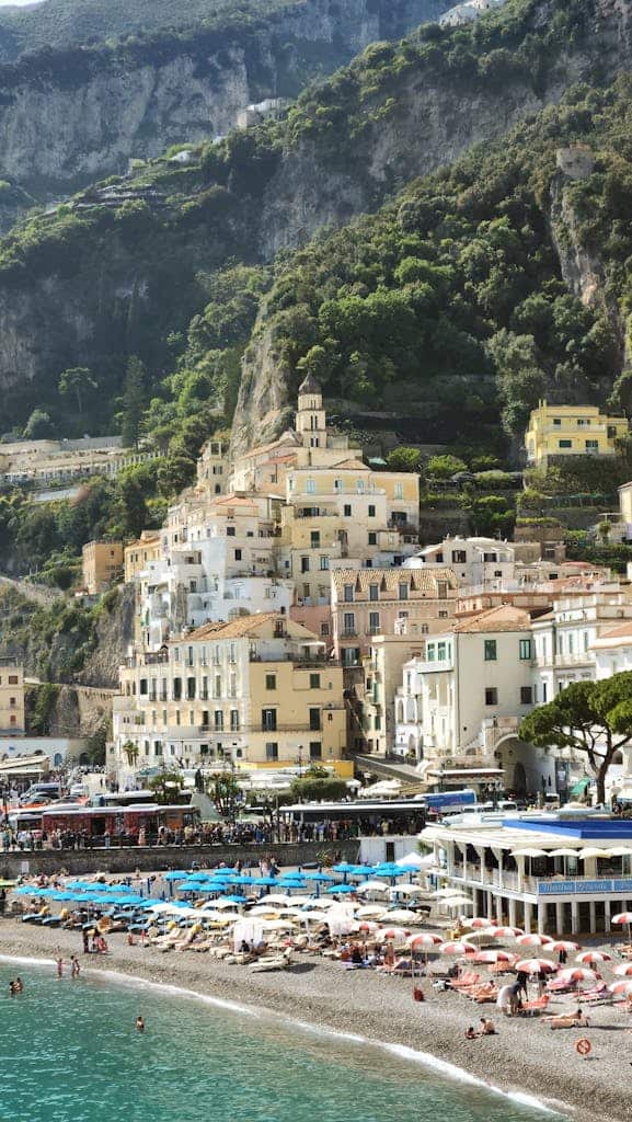 Stunning view of the Amalfi Coast with colorful umbrellas and historic architecture.