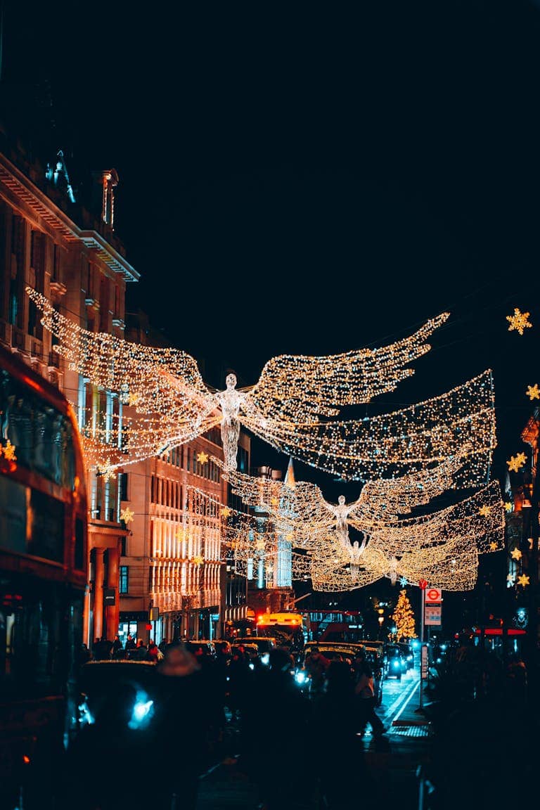 Illuminate the festive spirit with stunning angel light decorations on London streets at night.