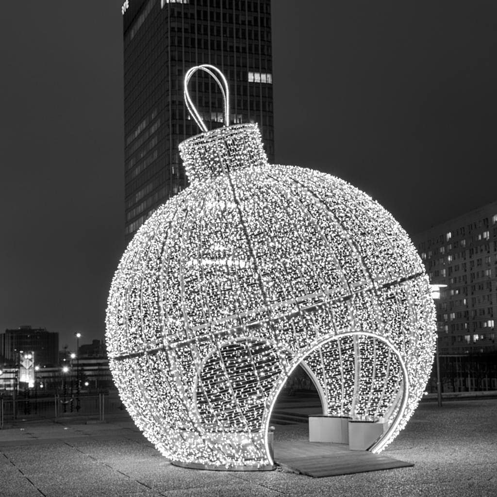 Stunning black and white photo of a large illuminated Christmas ornament in Courbevoie, Île-de-France.