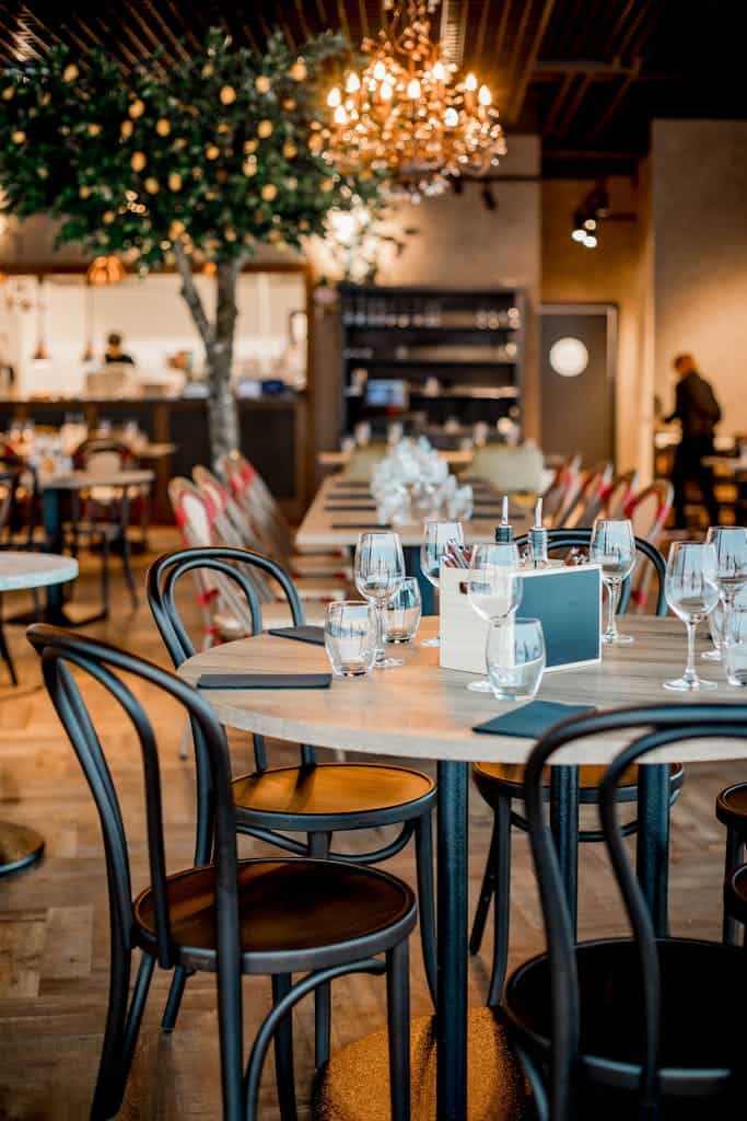 Stylish restaurant interior with lemon tree and elegant table setting, perfect for dining ambiance.
