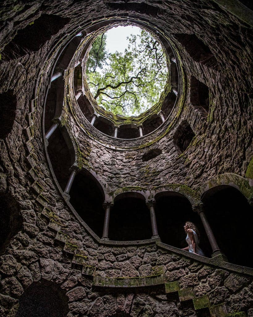 Explore the mystical spiral well of Quinta da Regaleira in Sintra, Portugal, with its captivating architectural design.