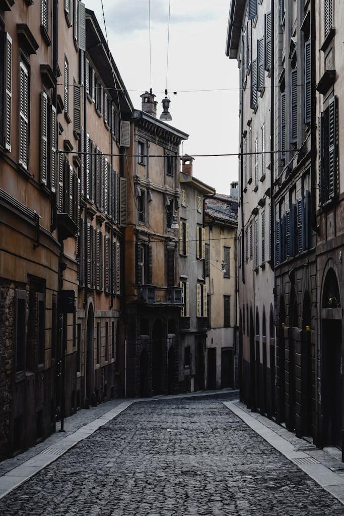 Explore the timeless beauty of an old town alley in Bergamo, Italy.