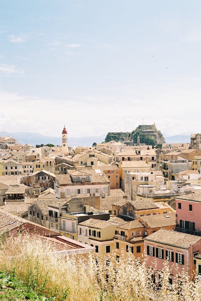 A picturesque aerial view of the charming old town of Corfu, Greece, showcasing its rustic rooftops and historic architecture.