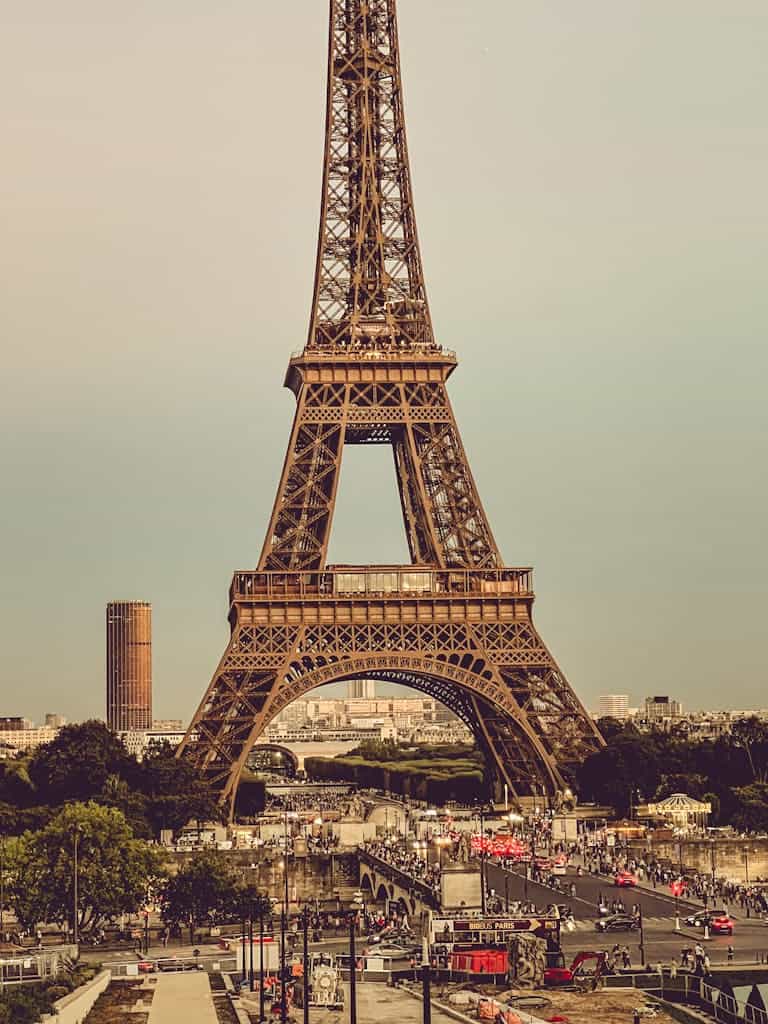 Stunning daytime capture of the Eiffel Tower in Paris, showcasing iconic architecture and bustling city life.