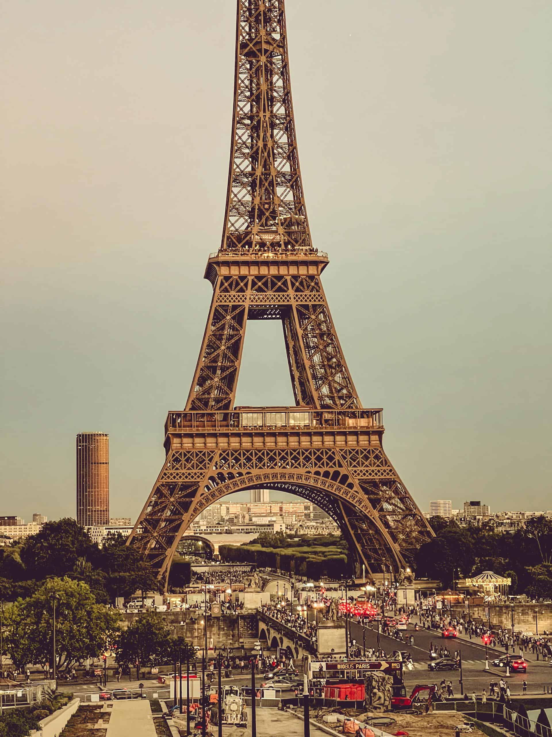 Stunning daytime capture of the Eiffel Tower in Paris, showcasing iconic architecture and bustling city life.