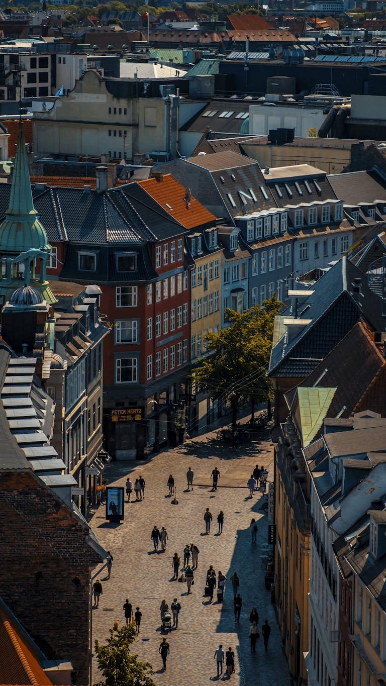 Explore the colorful architecture and lively streets of Copenhagen from above, capturing the city's vibrant urban allure.
