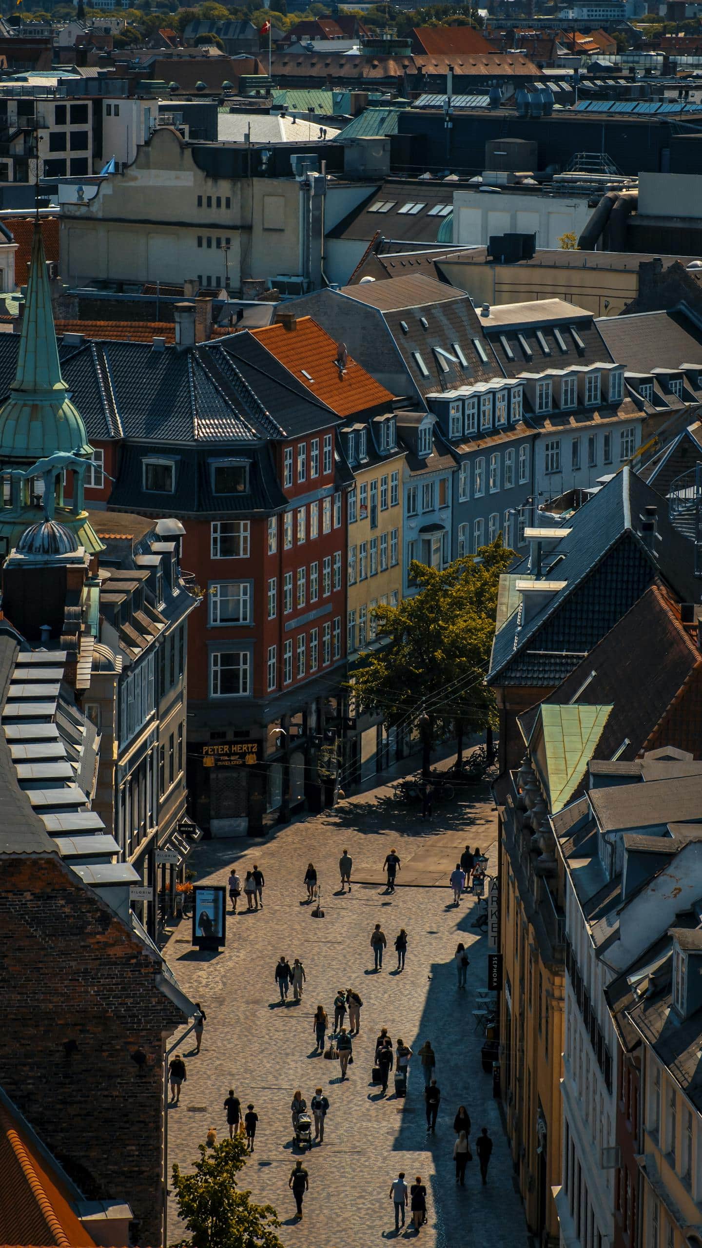 Explore the colorful architecture and lively streets of Copenhagen from above, capturing the city's vibrant urban allure.