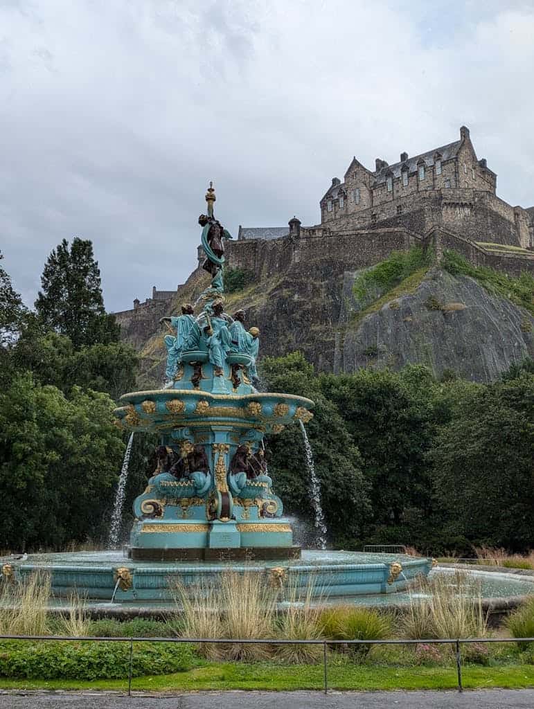 View of the iconic Ross Fountain with Edinburgh Castle perched on the hill above, creating a picturesque scene.