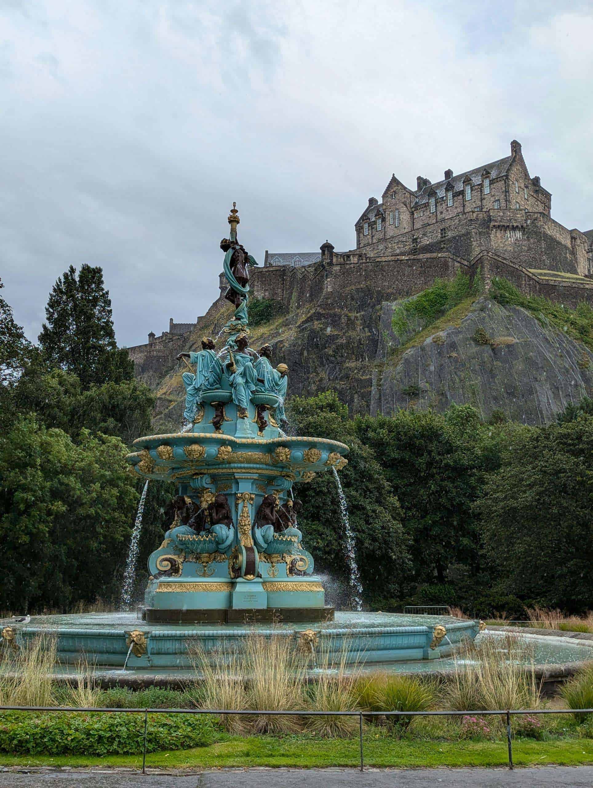 View of the iconic Ross Fountain with Edinburgh Castle perched on the hill above, creating a picturesque scene.