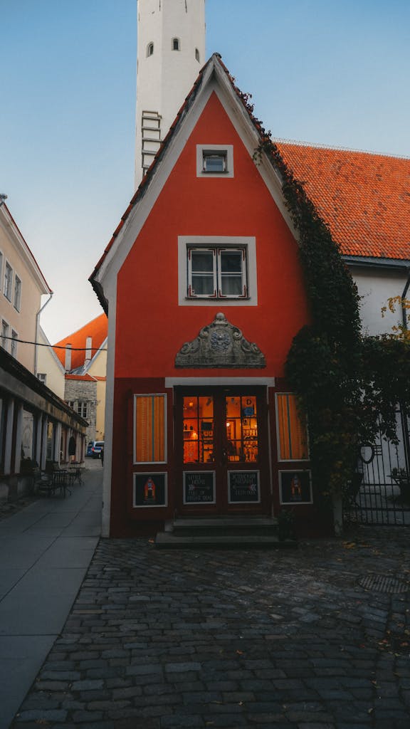 A picturesque house with cobblestone street in Tallinn's Old Town captured at dusk.